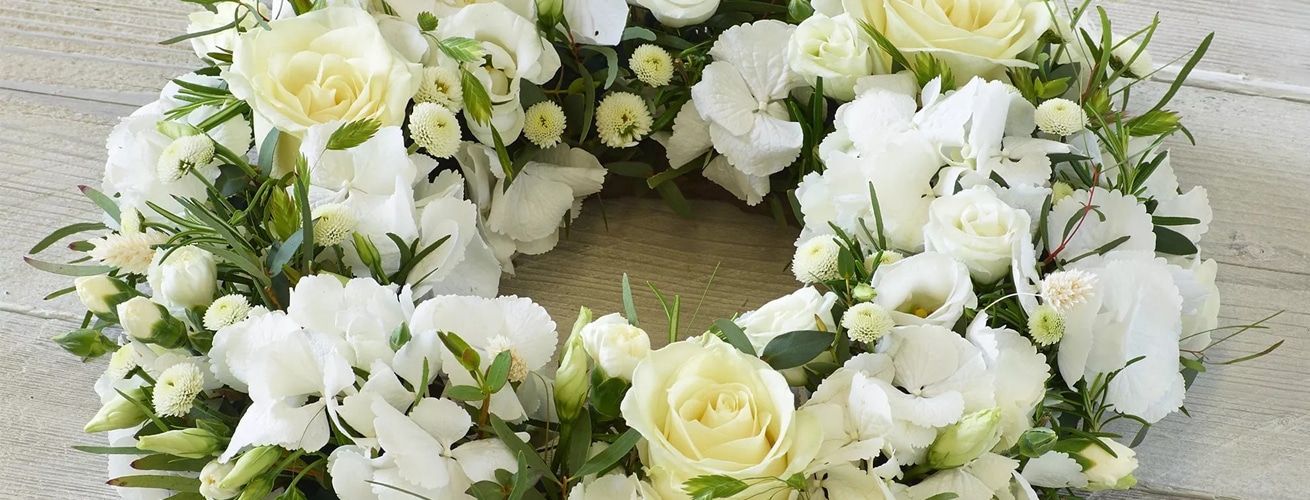 White and yellow flower bouquet with sympathy message reading 'with deepest sympathy