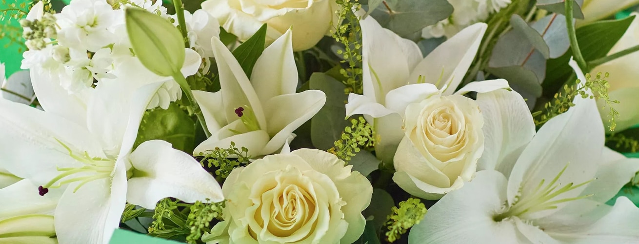 Sympathy flower bouquet of white roses and lilies