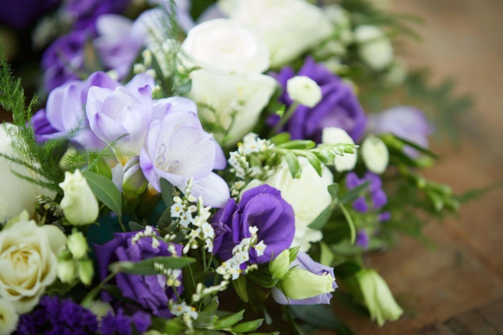 Bouquet of bright yellow, purple, and white freesias