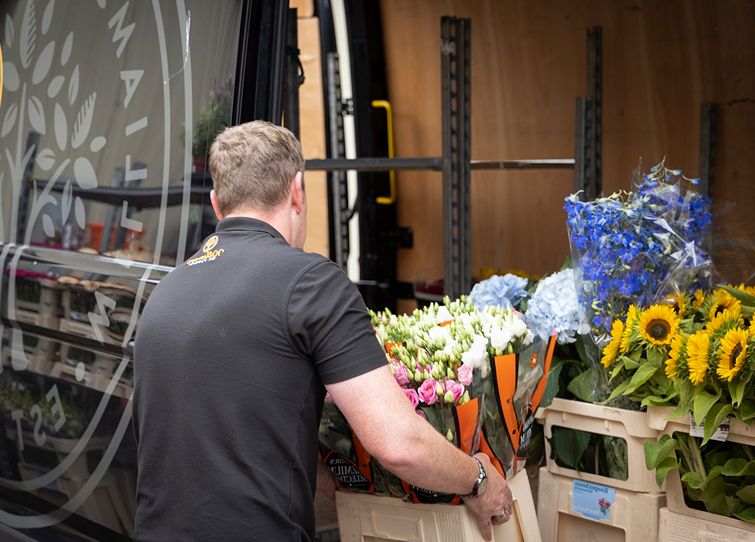 Florist from Williamson's My Florist loading fresh seasonal flowers into a branded van for Scottish flower delivery